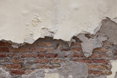 off-whited-plastered-with-bricks-textured-wall-Venice-Italy