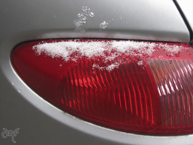 snow on tail light of a car
