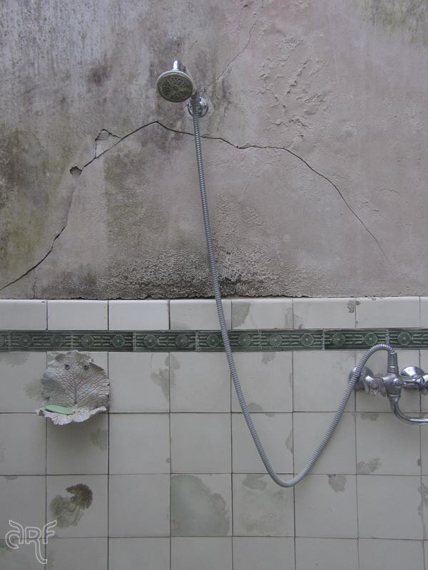 old shower in decayed bathroom