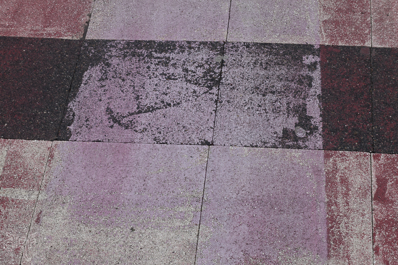 faded pink paint on sidewalk