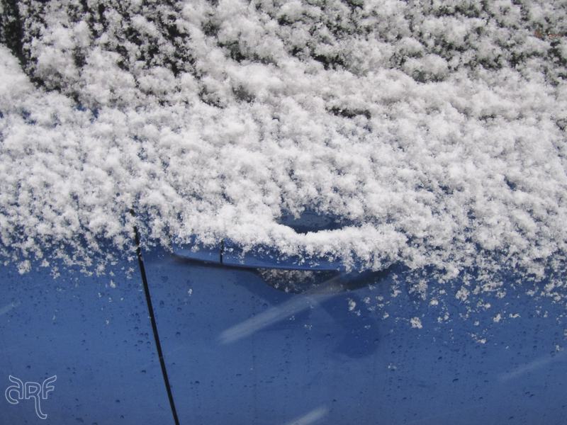 snow on blue car