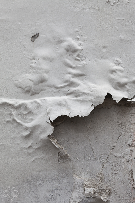chipped paint on a white washed wall