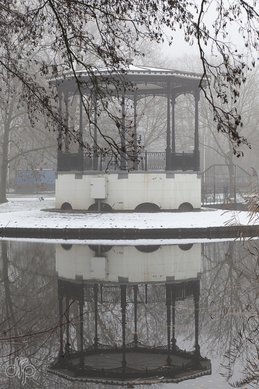 serene and snowy reflection of music arbor in the Vondelpark, Amsterdam