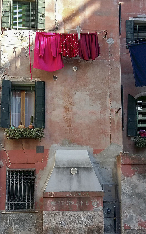 red laundry in front of a red house in Venice, Italy