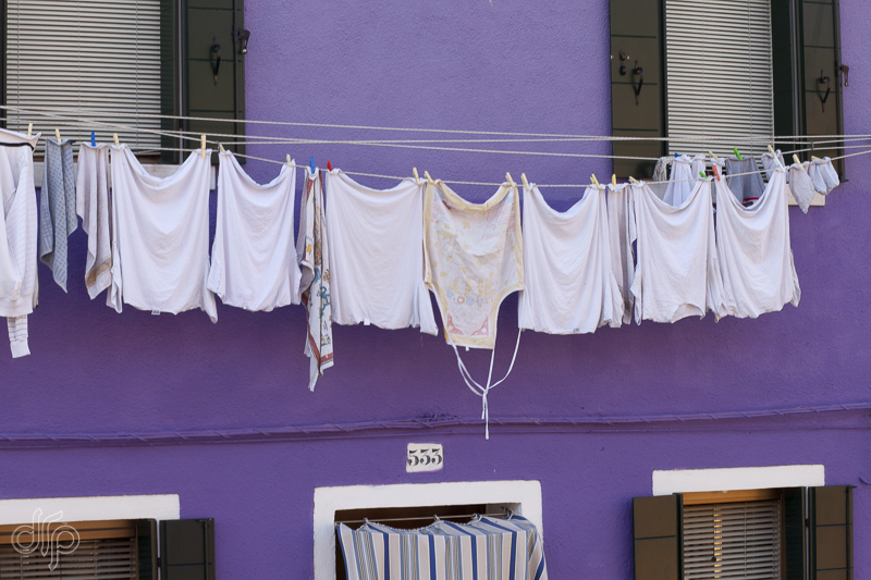white laundry at lilac house in Burano, Italy