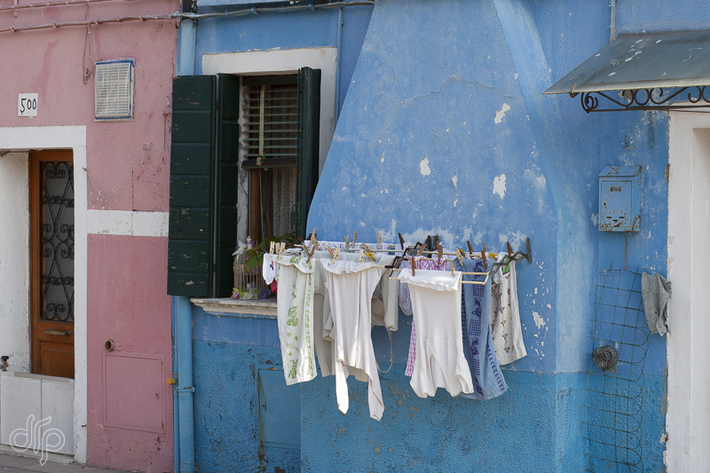 little laundry at a blue house in Burano, Italy