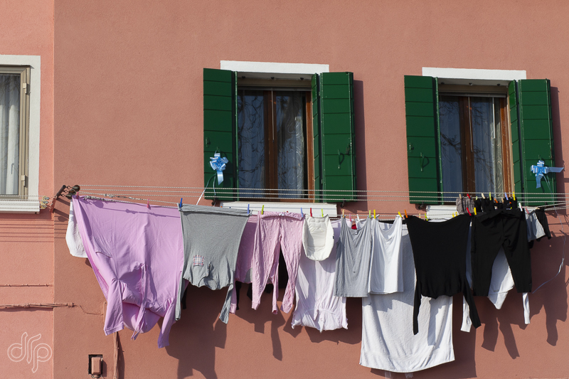 laundry at a terracotta colored house in Burano Italy