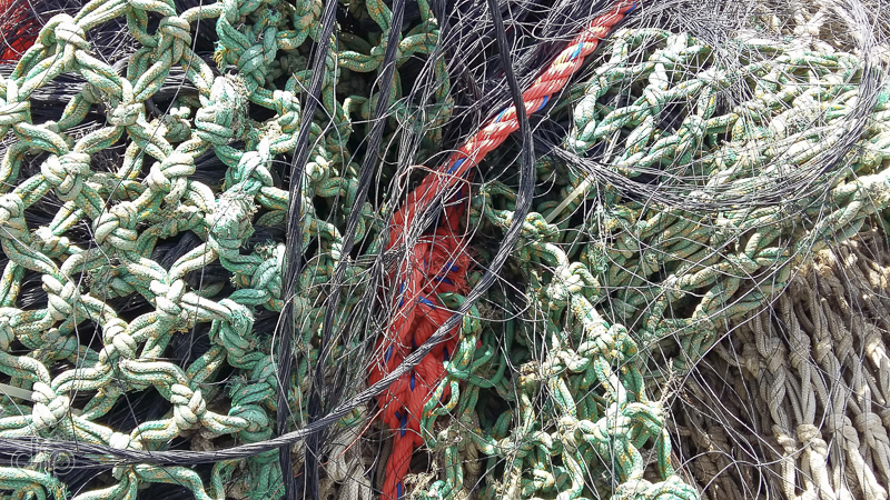 green fishing nets and an orange rope