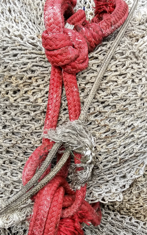 thick orange rope with fishing nets