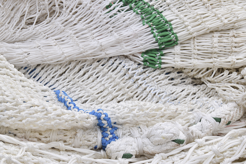 Folded fishing nets with blue and green lines