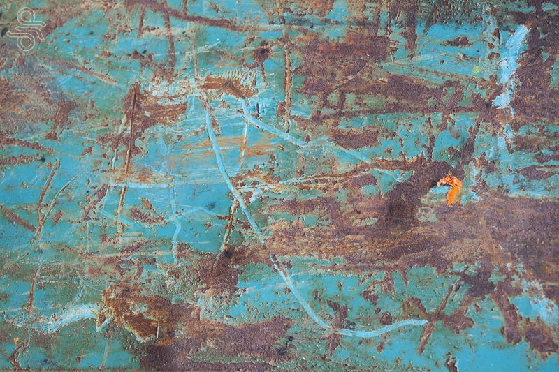 teal surface with rust