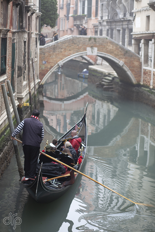 Quiet canal with gondolier in Venice, Italy