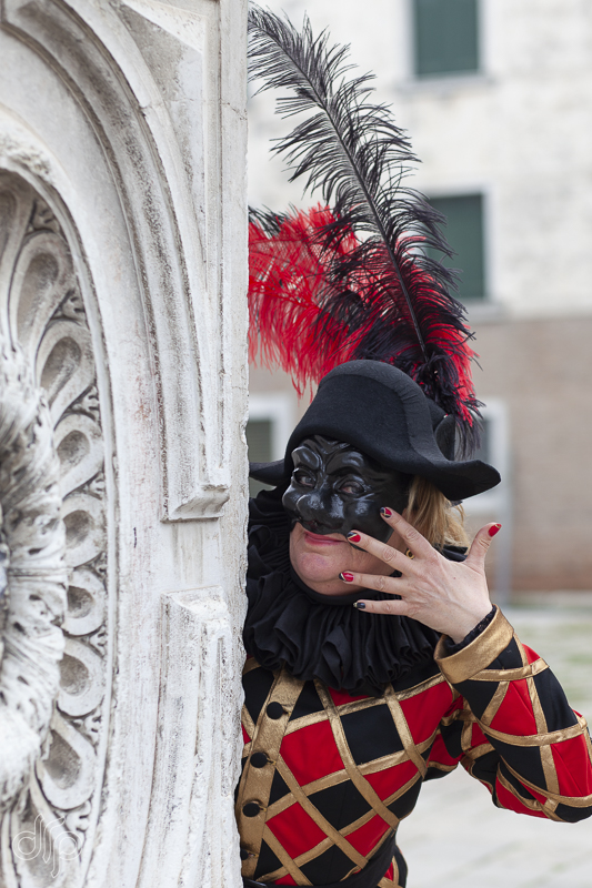 The character of Arlecchina from Commedia dell'Arte posing in Venice, Italy