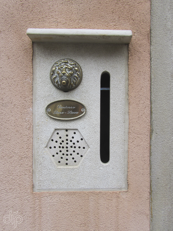 Doorbell and light pink coloured wall in Venice, Italy