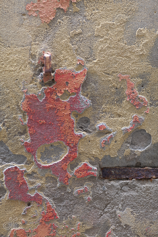 Hot orange and red coloured textured wall in Venice, Italy