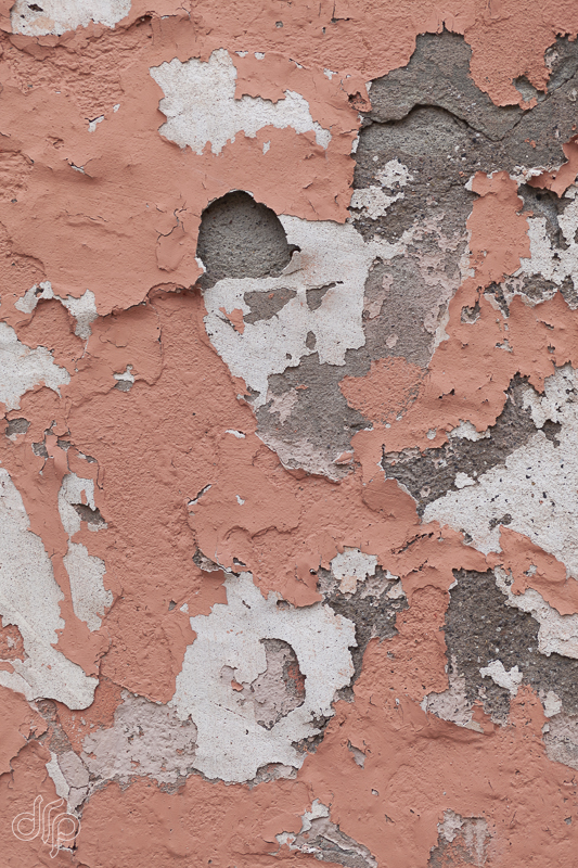 Salmon colored peeling-paint-textured wall in Venice, Italy