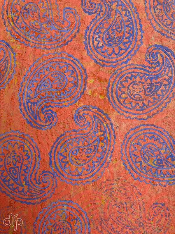 Gelli plate pattern with coral background and blue paisley